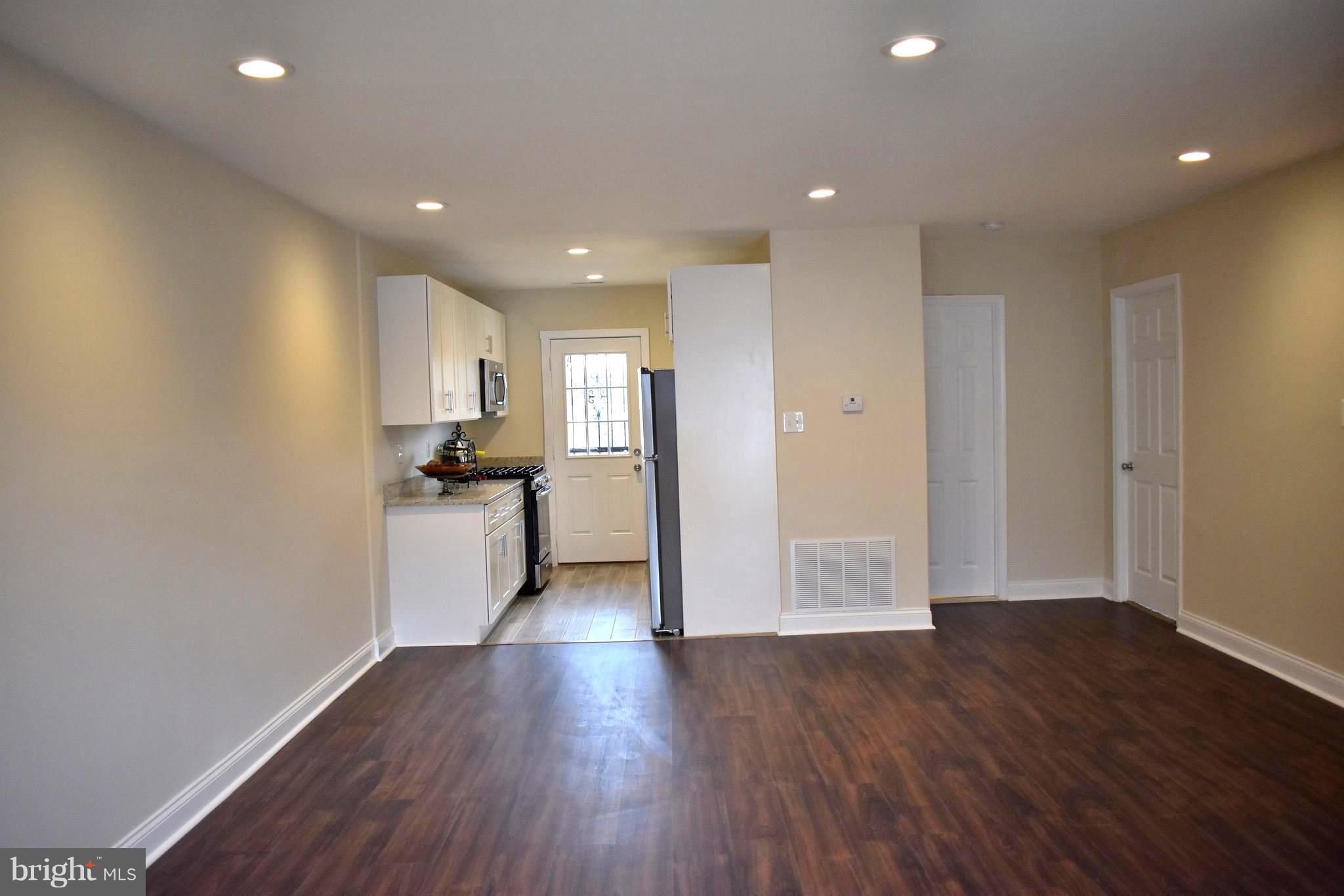 7733 Oxman Road Landover, MD 20785 - Photo 3 of 19 a view of a large kitchen with wooden floor