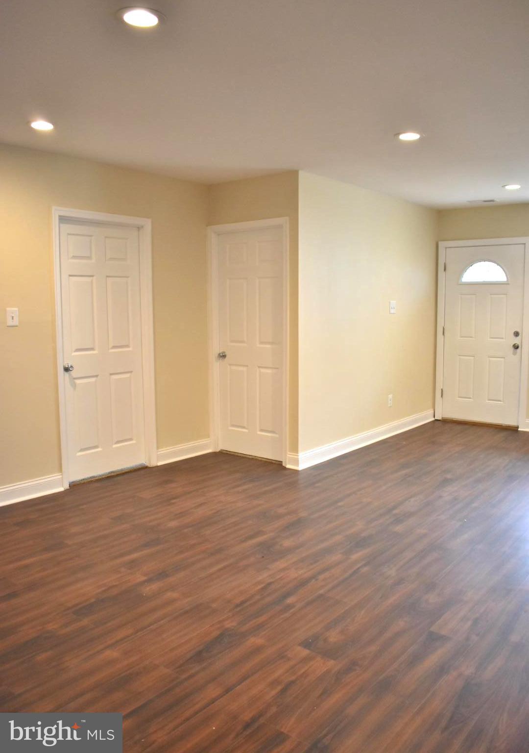7733 Oxman Road Landover, MD 20785 - Photo 7 of 19 a view of an empty room with wooden floor