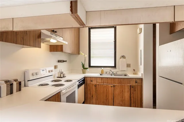 a kitchen with a sink a stove and refrigerator
