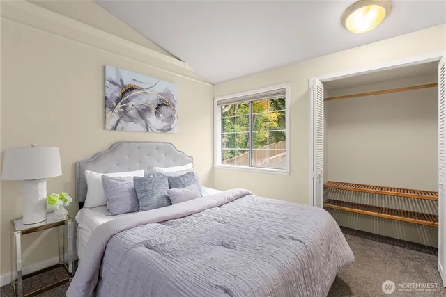 a bedroom with a bed and a painting on the wall