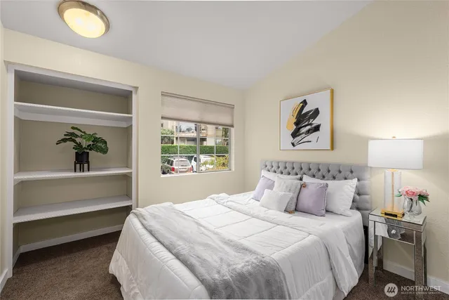 a bedroom with a bed and a window