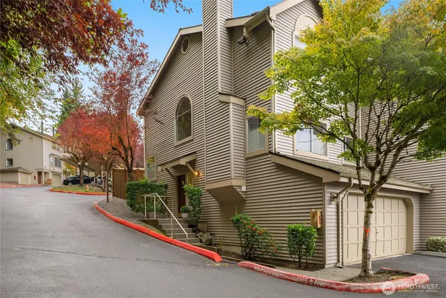 a view of street along with house and trees