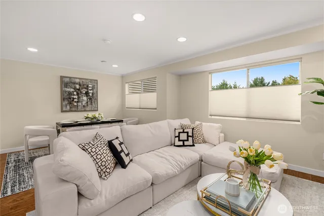 a living room with furniture flowerpot and window