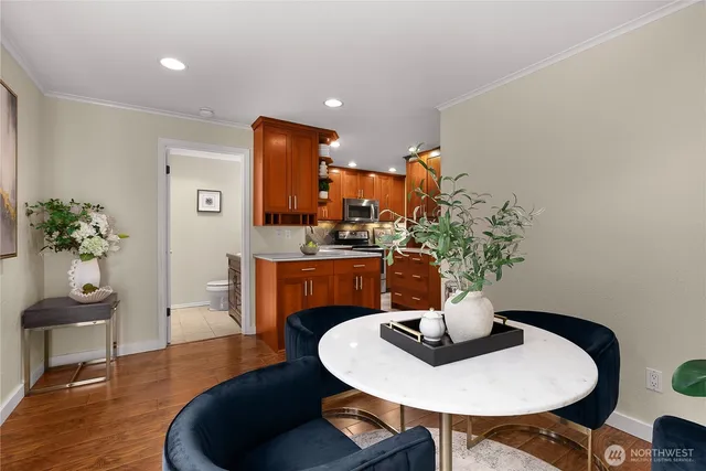 a dining room with furniture and wooden floor