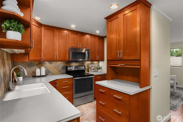 a kitchen with a refrigerator stove and sink