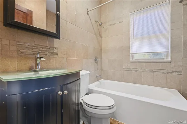 a bathroom with a sink a toilet and bathtub