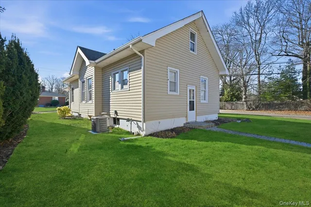 a front view of house with yard and green space