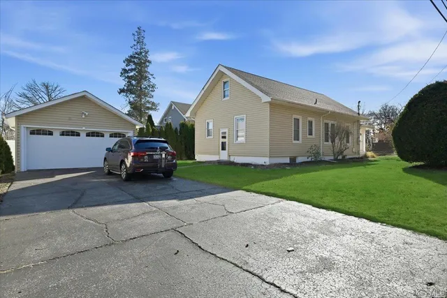 a car parked in front of a house with a yard