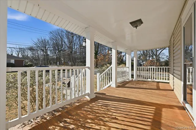 a view of a balcony with wooden floor