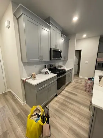 a kitchen with a sink appliances and cabinets