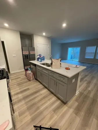 a living room with a bed and a dresser