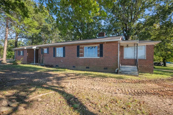 a view of a house with a yard and garage