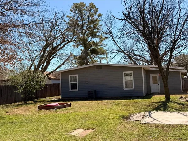 a house that has a tree in front of it