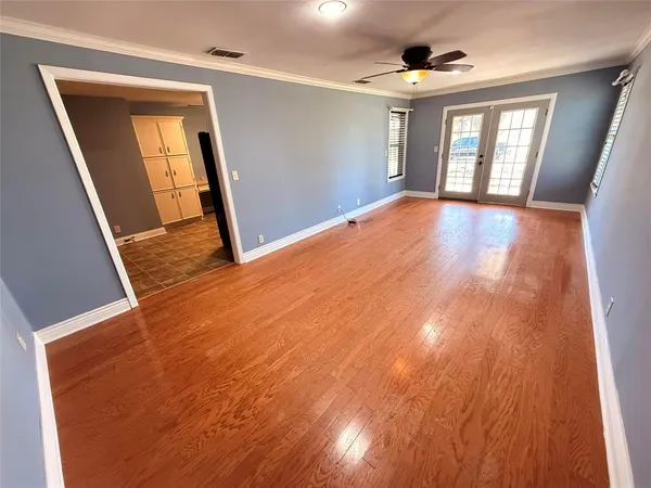 wooden floor in an empty room with a window