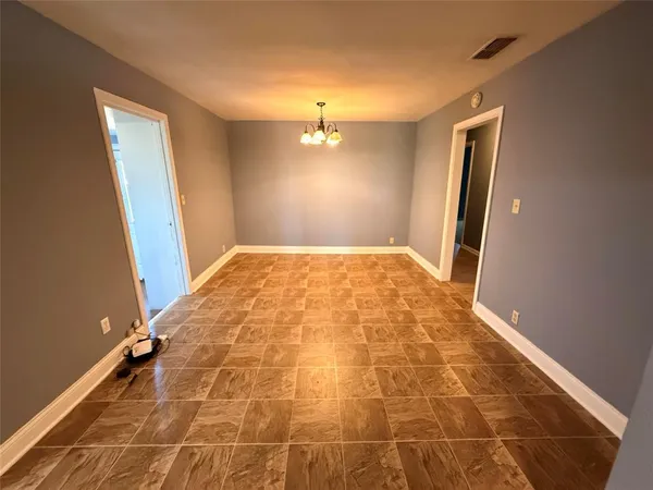a view of an empty room and a bathroom