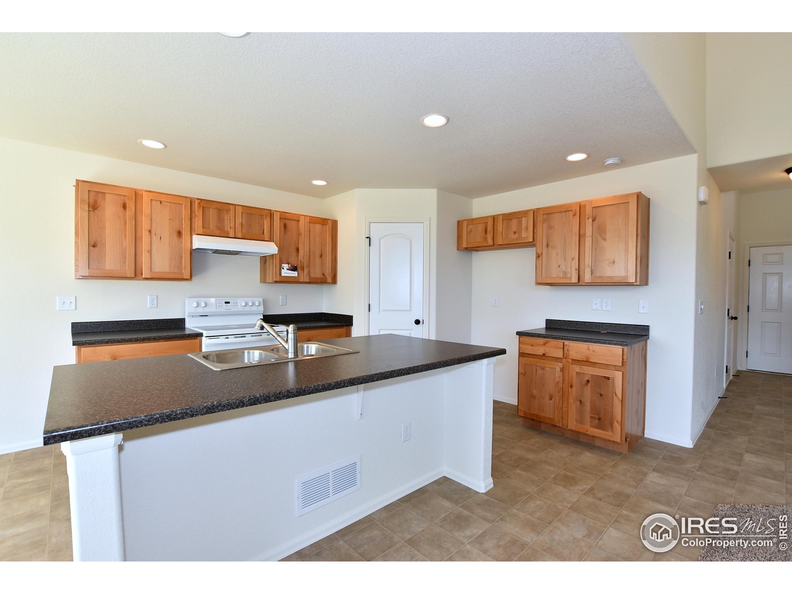 620 87th Avenue Greeley, CO 80634 - Photo 14 of 39 a kitchen with stainless steel appliances granite countertop a sink and a stove