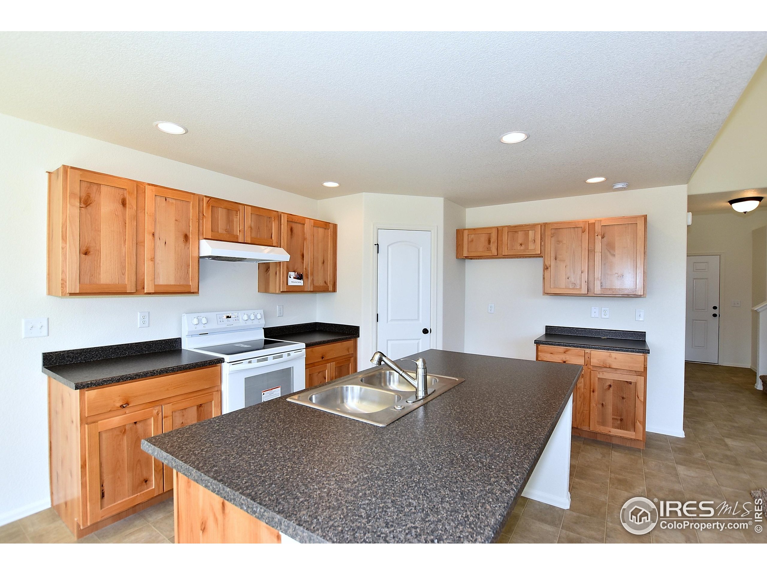 620 87th Avenue Greeley, CO 80634 - Photo 19 of 39 a kitchen with stainless steel appliances granite countertop a sink stove and refrigerator