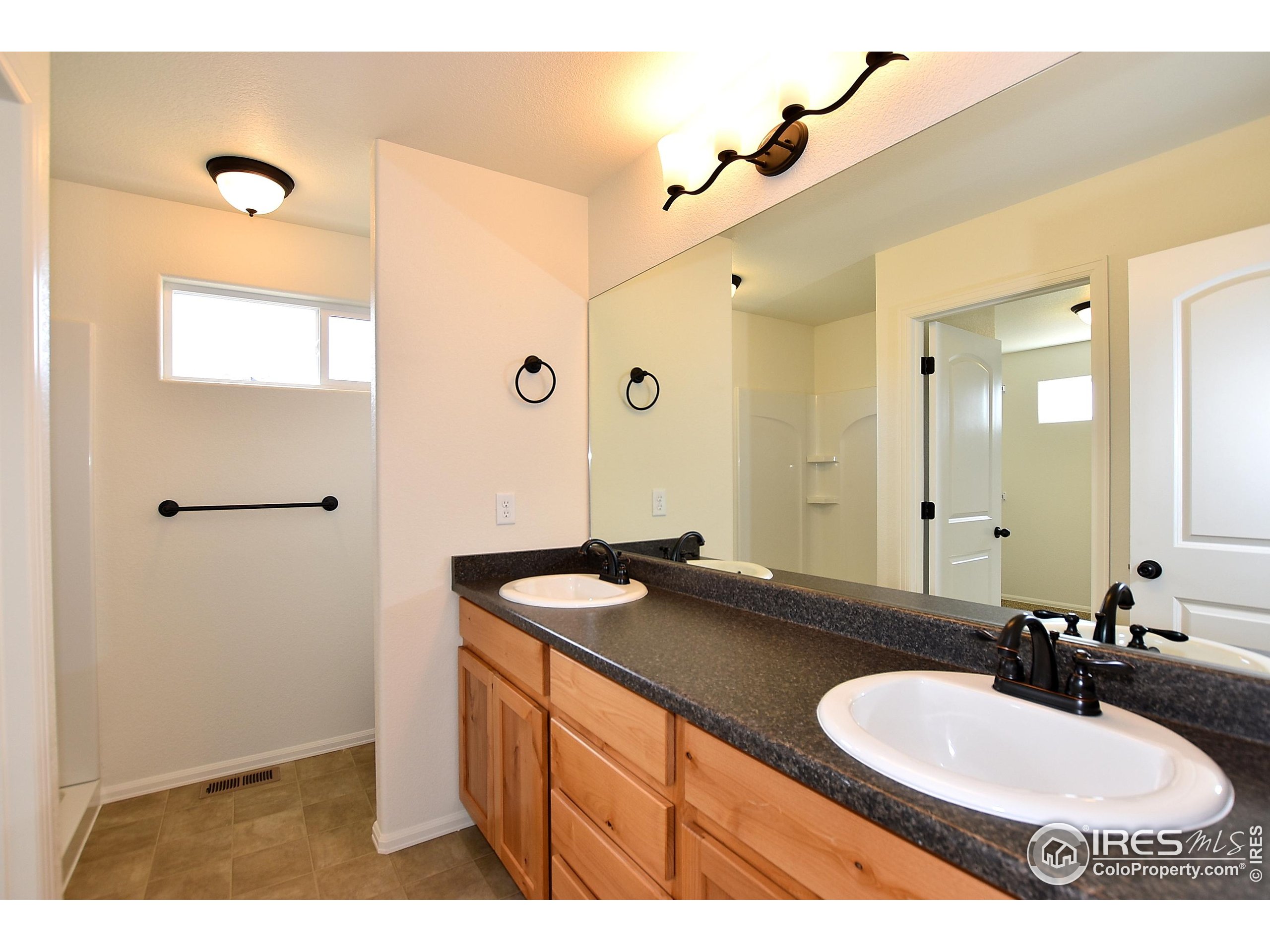620 87th Avenue Greeley, CO 80634 - Photo 25 of 39 a bathroom with a sink and a mirror