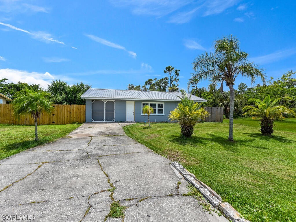 26499 Eager Road Punta Gorda, FL 33955 - Photo 1 of 21 a front view of a house with a yard and garage