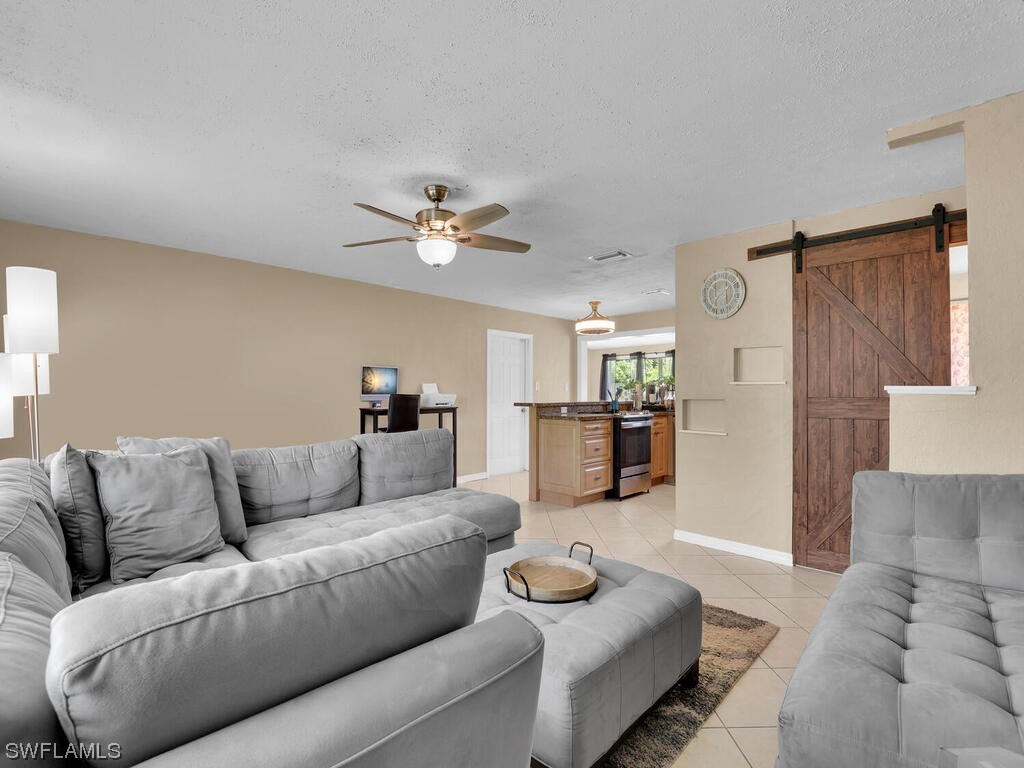 26499 Eager Road Punta Gorda, FL 33955 - Photo 11 of 21 a living room with furniture and a chandelier