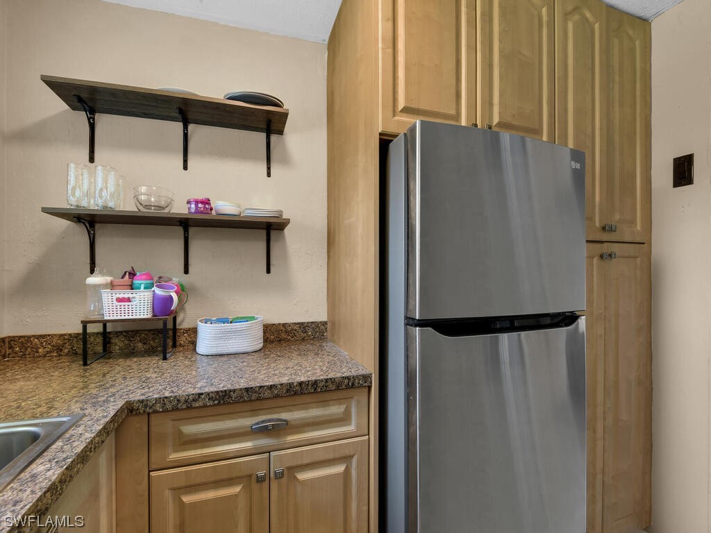 26499 Eager Road Punta Gorda, FL 33955 - Photo 14 of 21 a kitchen with stainless steel appliances granite countertop a refrigerator and a sink