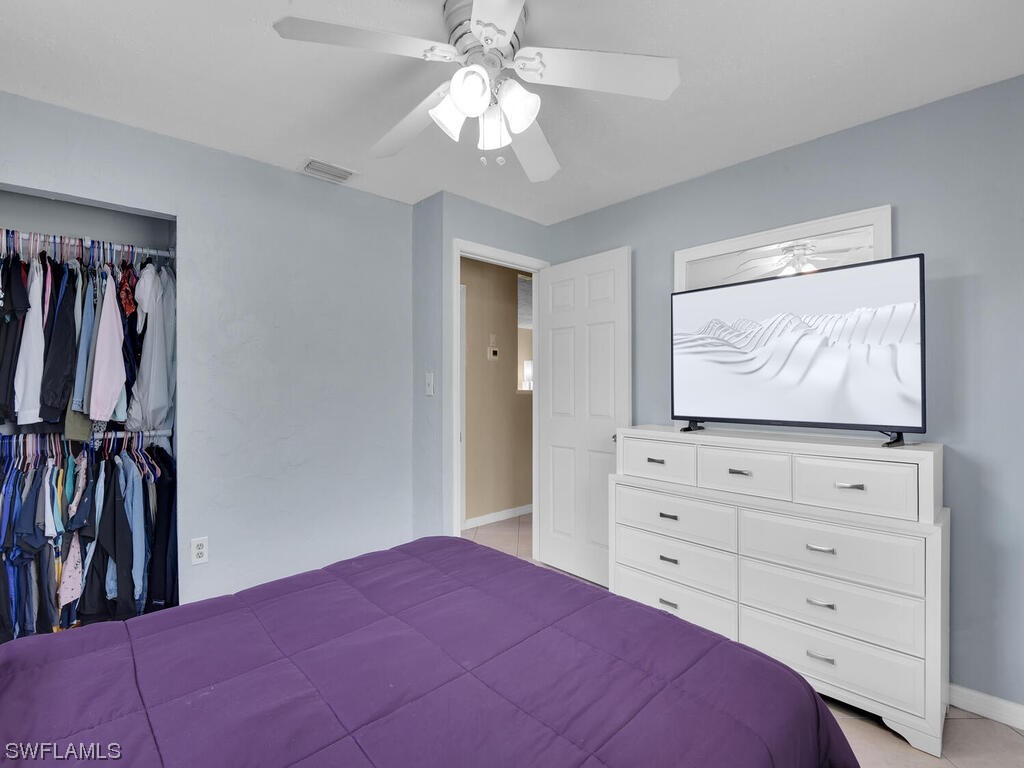 26499 Eager Road Punta Gorda, FL 33955 - Photo 18 of 21 a bedroom with a bed and a mirror on dresser