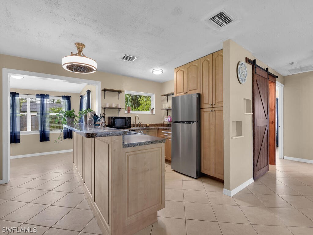 26499 Eager Road Punta Gorda, FL 33955 - Photo 3 of 21 a kitchen with stainless steel appliances granite countertop a refrigerator and a sink