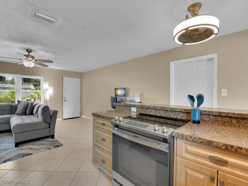 26499 Eager Road Punta Gorda, FL 33955 - Photo 4 of 21 a kitchen with stainless steel appliances granite countertop a stove and a sink