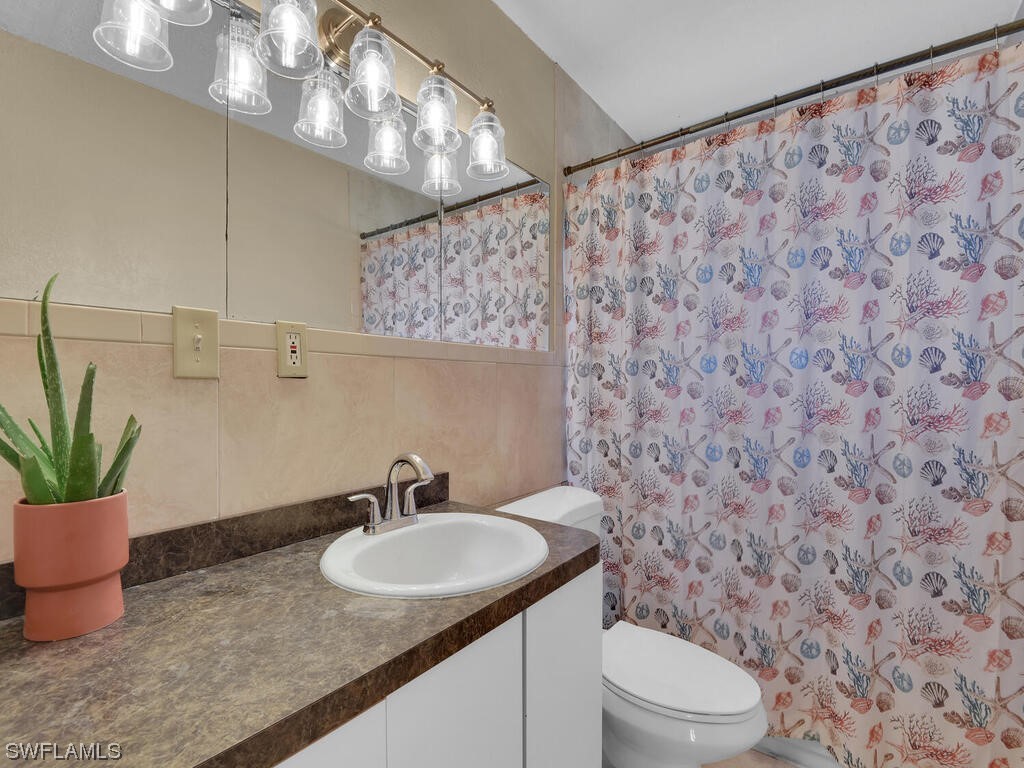 26499 Eager Road Punta Gorda, FL 33955 - Photo 7 of 21 a bathroom with a granite countertop sink and a mirror