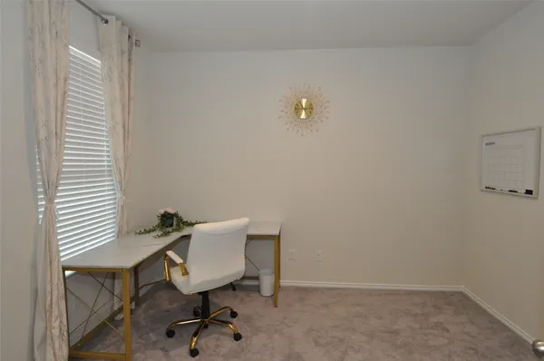 a bedroom with a bed tv and window