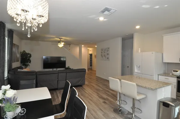 a large kitchen with a table and chairs in it