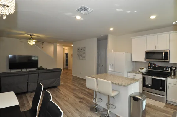 a kitchen with stainless steel appliances granite countertop a sink refrigerator and microwave