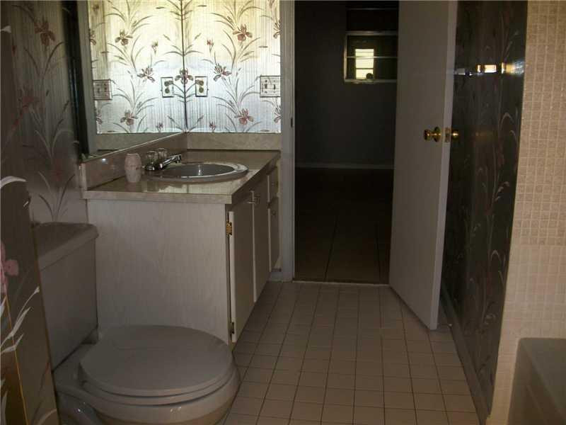 9949 Sandalfoot Boulevard, Unit 542 Boca Raton, FL 33428 - Photo 5 of 8 a bathroom with a toilet and a sink