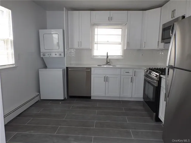 a kitchen with stainless steel appliances a refrigerator sink and cabinets