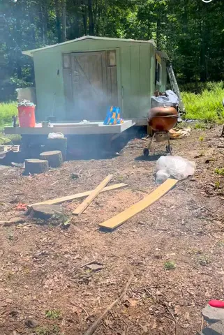 a backyard of a house with table and chairs