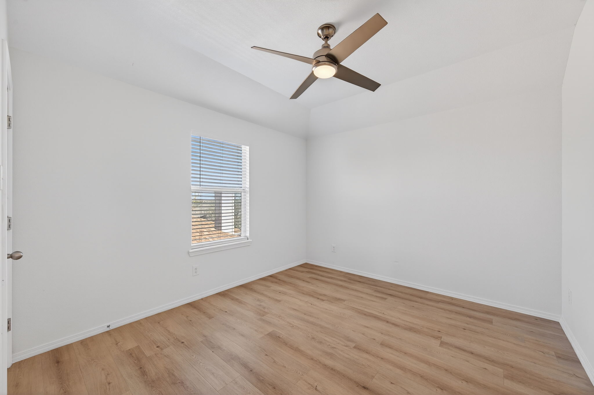 2305 Gavin Trail Pflugerville, TX 78660 - Photo 23 of 40 a view of a big room with wooden floor a ceiling fan and windows