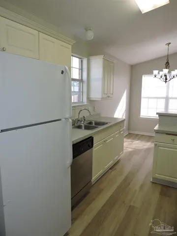 a kitchen with a sink and a refrigerator