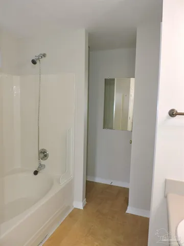 a bathroom with a bathtub and a toilet