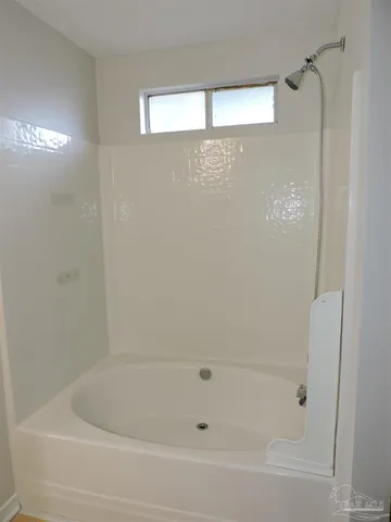 a bathroom with a bathtub and shower
