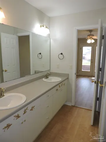 a bathroom with a sink double vanity granite tub and shower