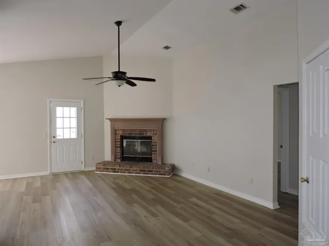 a view of a livingroom with a fireplace and window