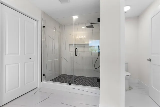 a bathroom with a shower and a toilet