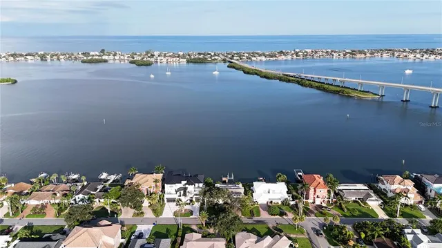 a aerial view of a house with swimming pool and a bench