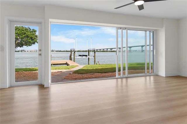 a view of a living room hardwood floor and a window