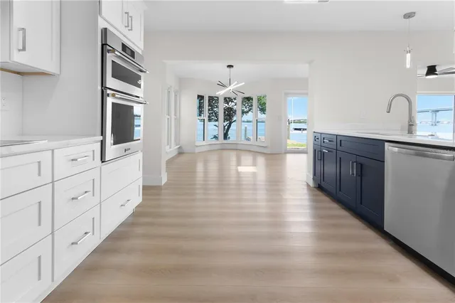 a large white kitchen with window