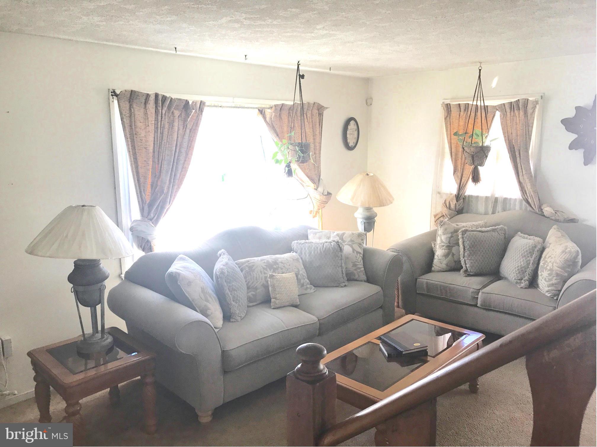 12055 Claridge Road Silver Spring, MD 20902 - Photo 2 of 10 a living room with furniture and a window