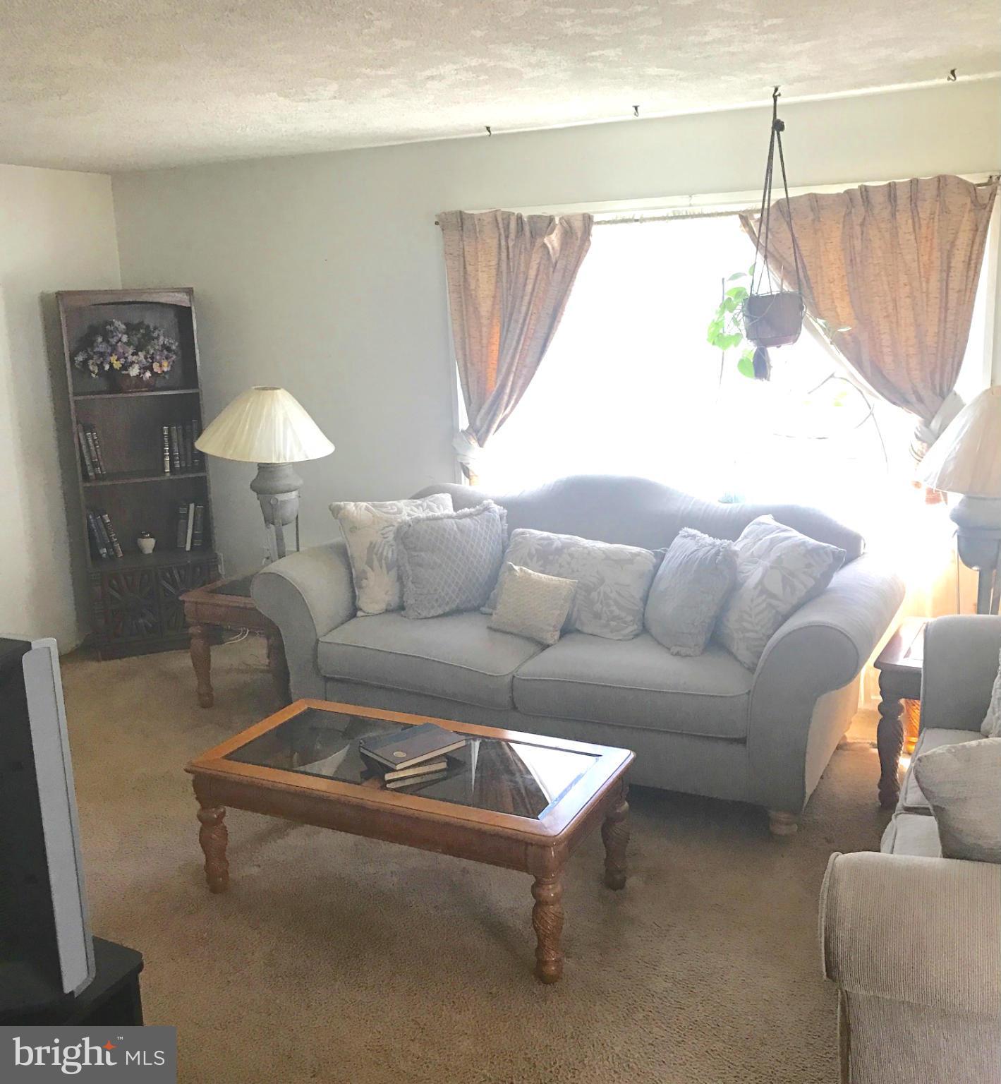 12055 Claridge Road Silver Spring, MD 20902 - Photo 3 of 10 a living room with furniture and a window