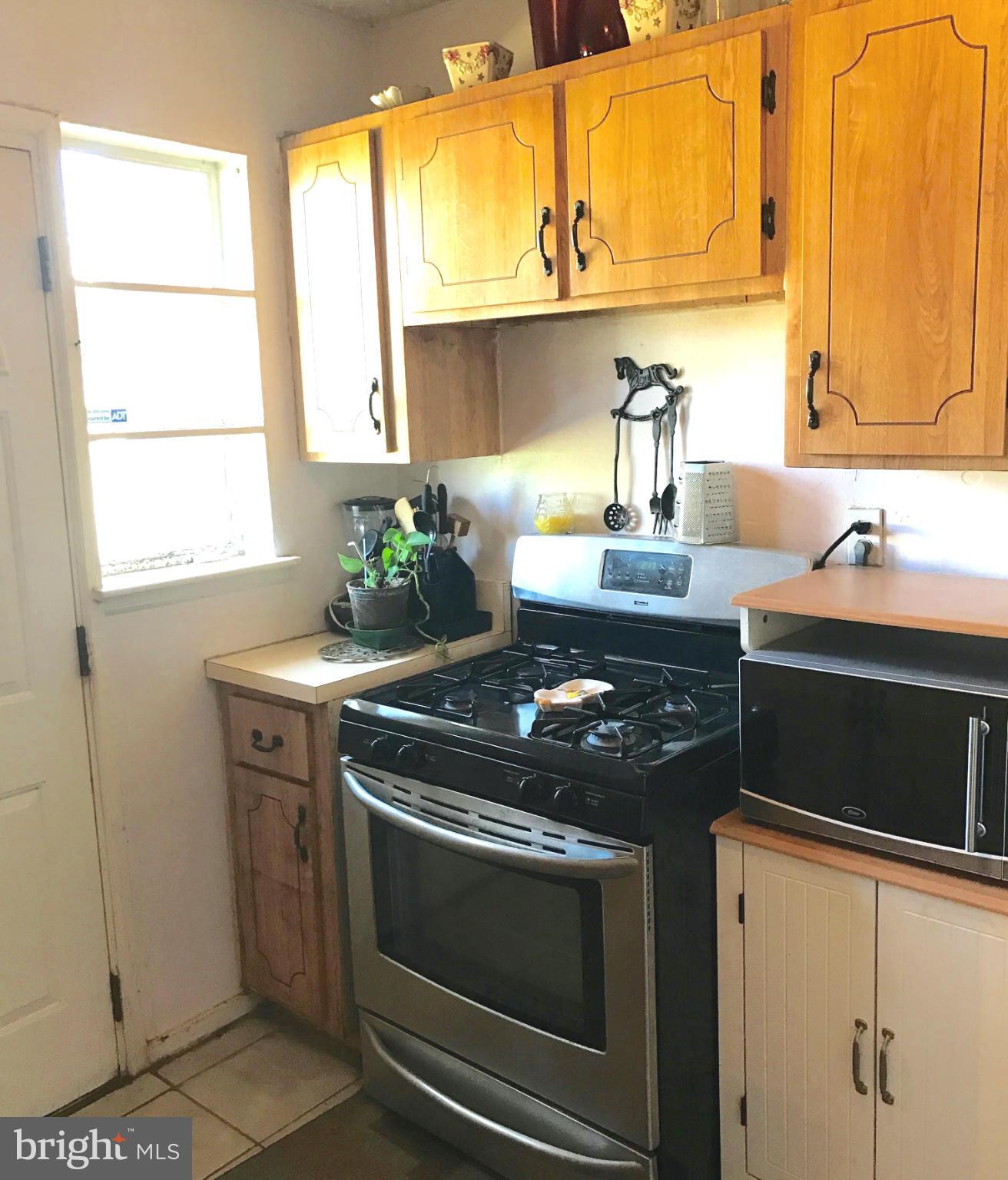 12055 Claridge Road Silver Spring, MD 20902 - Photo 6 of 10 a kitchen with a stove and a sink