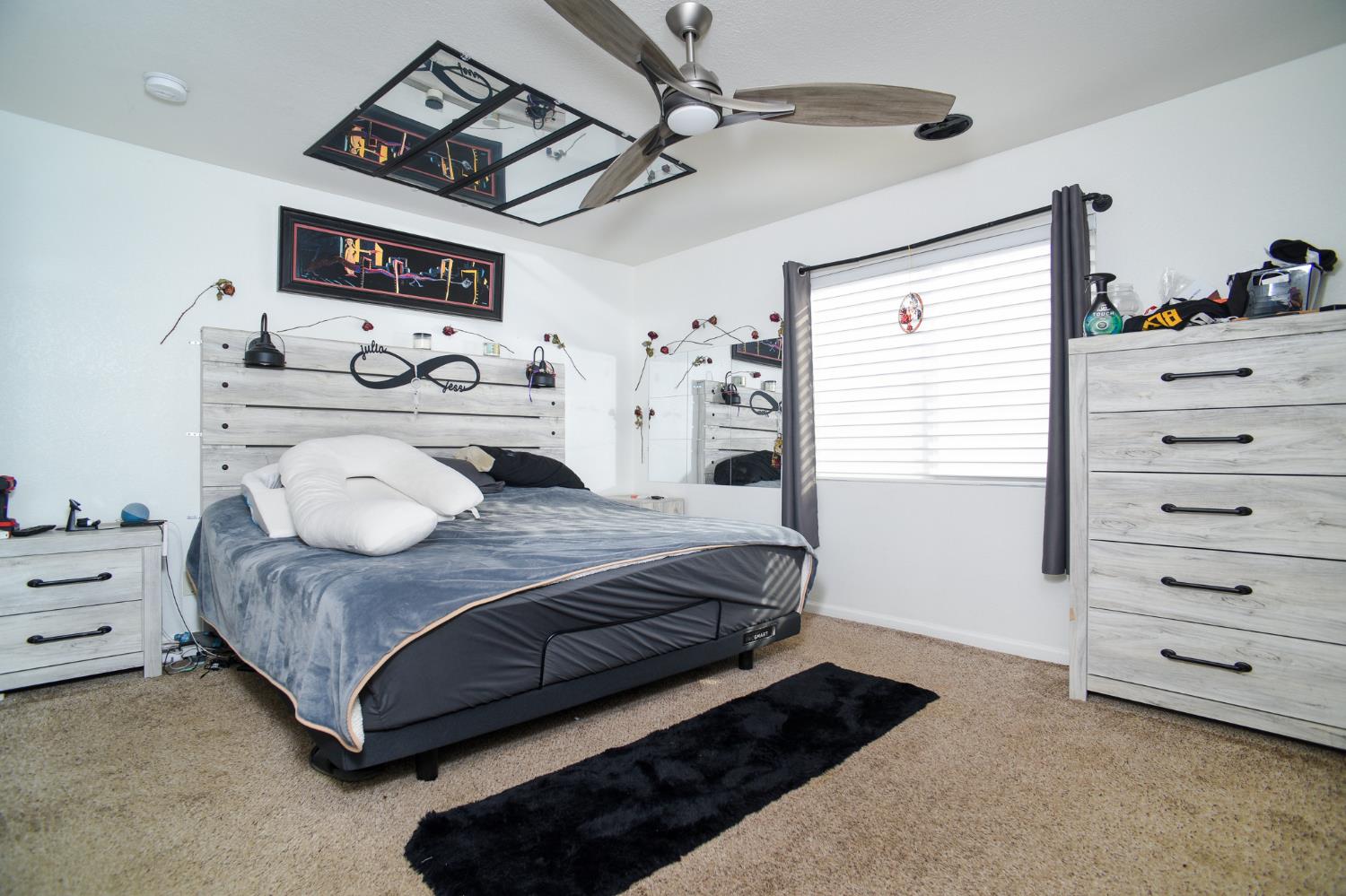 8567 Bradshaw Road Elk Grove, CA 95624 - Photo 4 of 12 a bedroom with a bed a dresser and potted plants