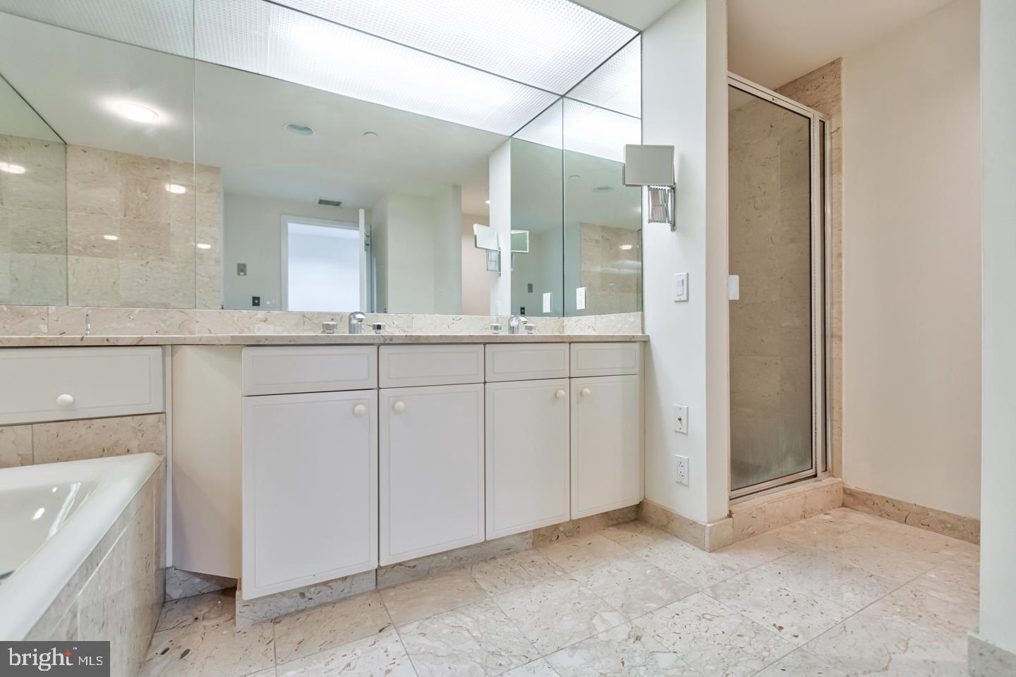 202-10 West Rittenhouse Square, Unit 1705 Philadelphia, PA 19103 - Photo 12 of 28 a bathroom with a double vanity sink and mirror